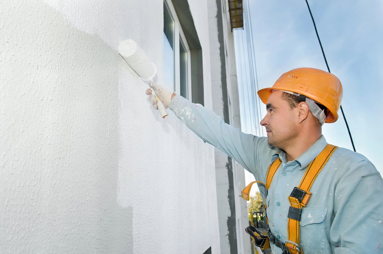 Contractor installing replacement window in coastal home living room