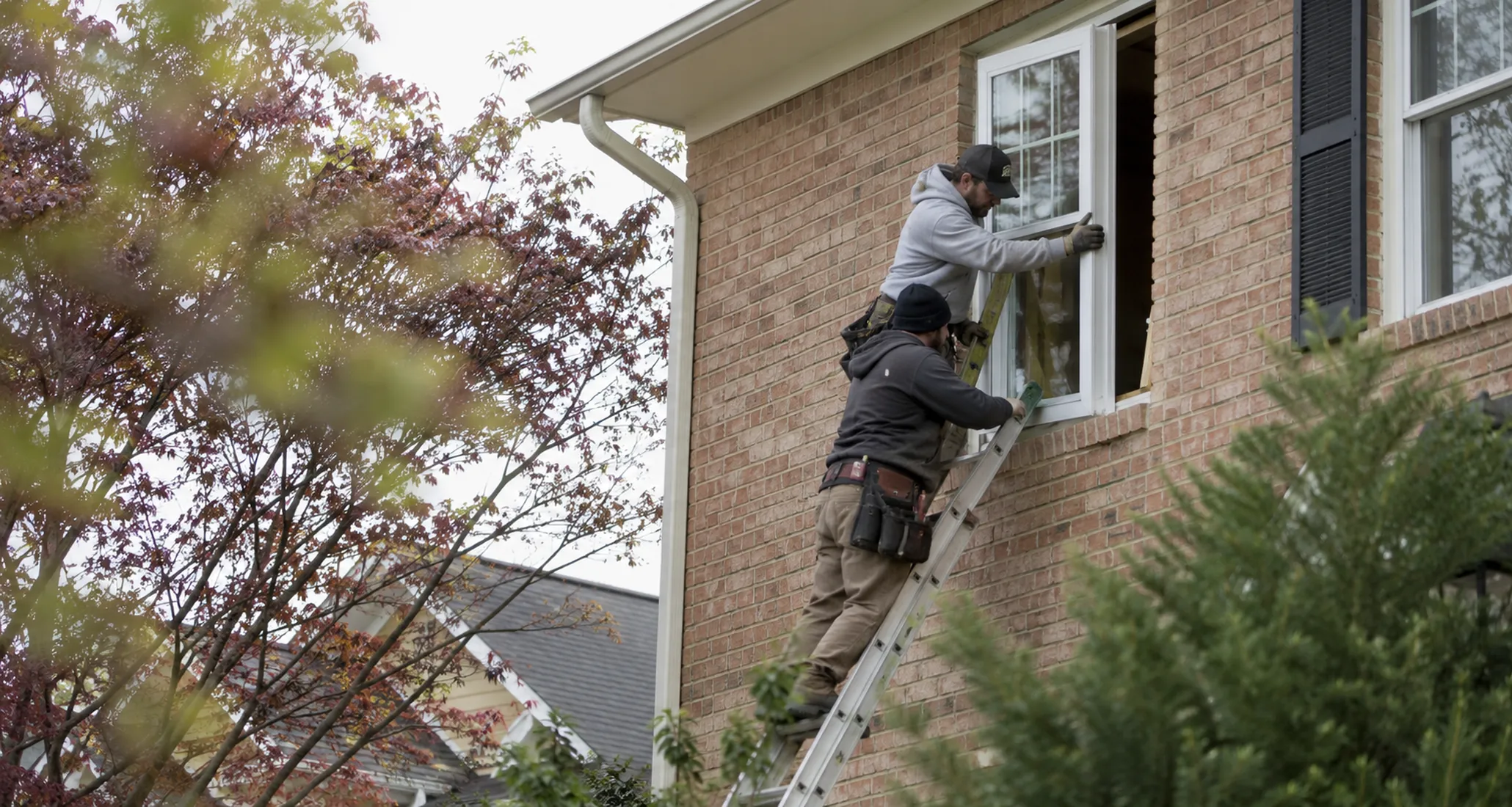 Window Replacement in Purdy - WA as a crew aligns a new frame in a living room